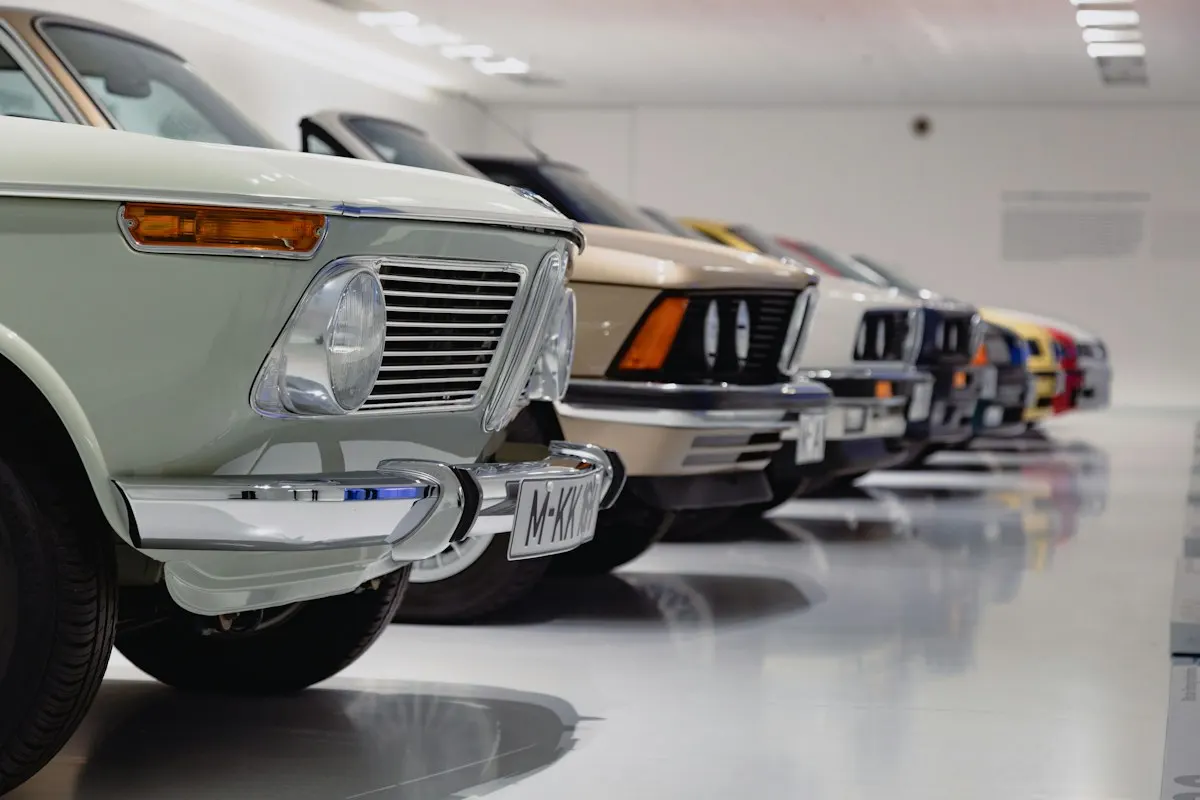 Row of classic cars on a glossy light-grey floor