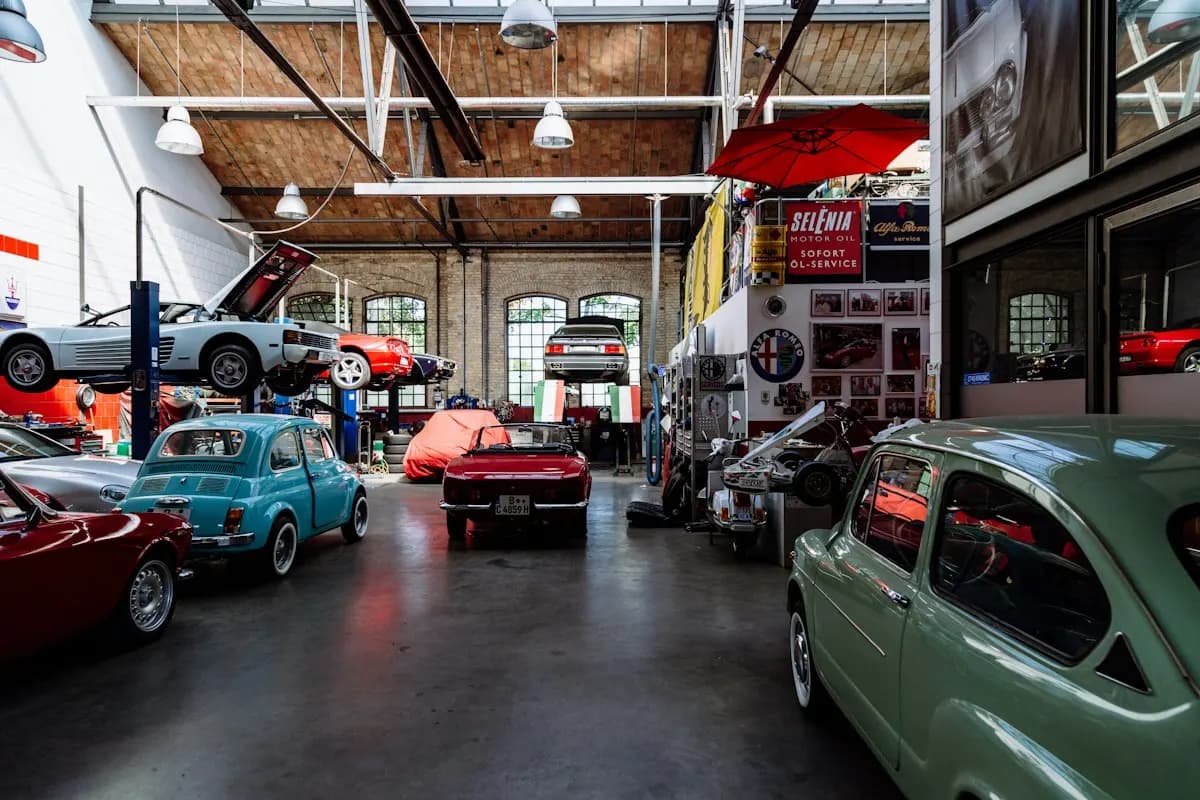 Vehicle workshop with a dark floor and large roof trusses