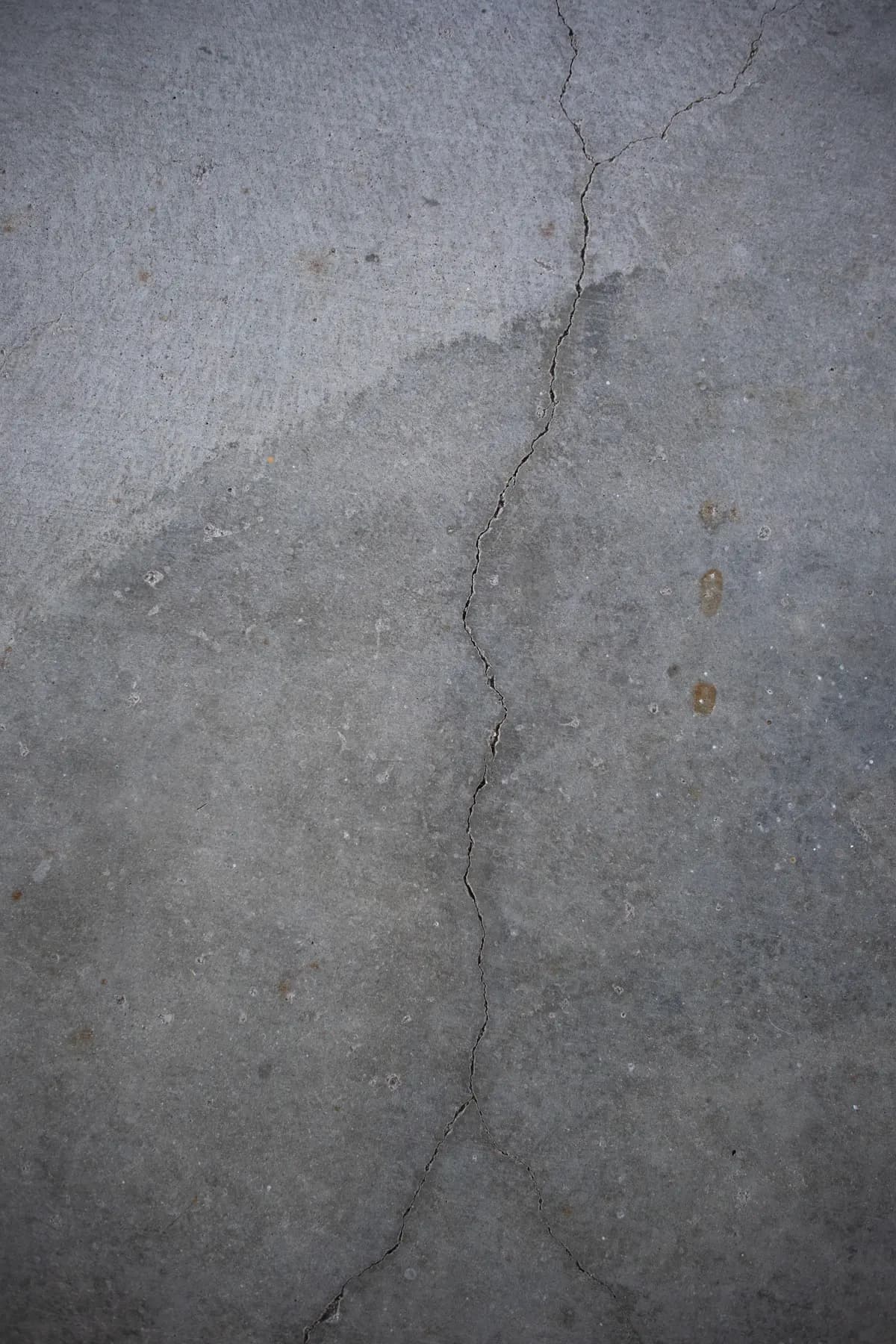 Crack running across a grey concrete slab