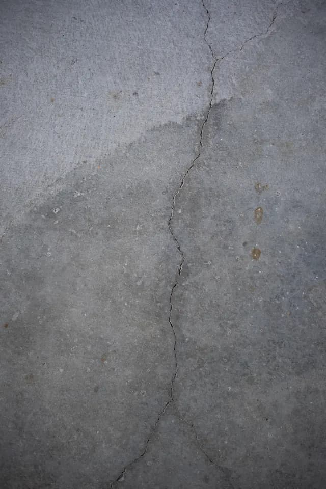 Crack running across a grey concrete slab